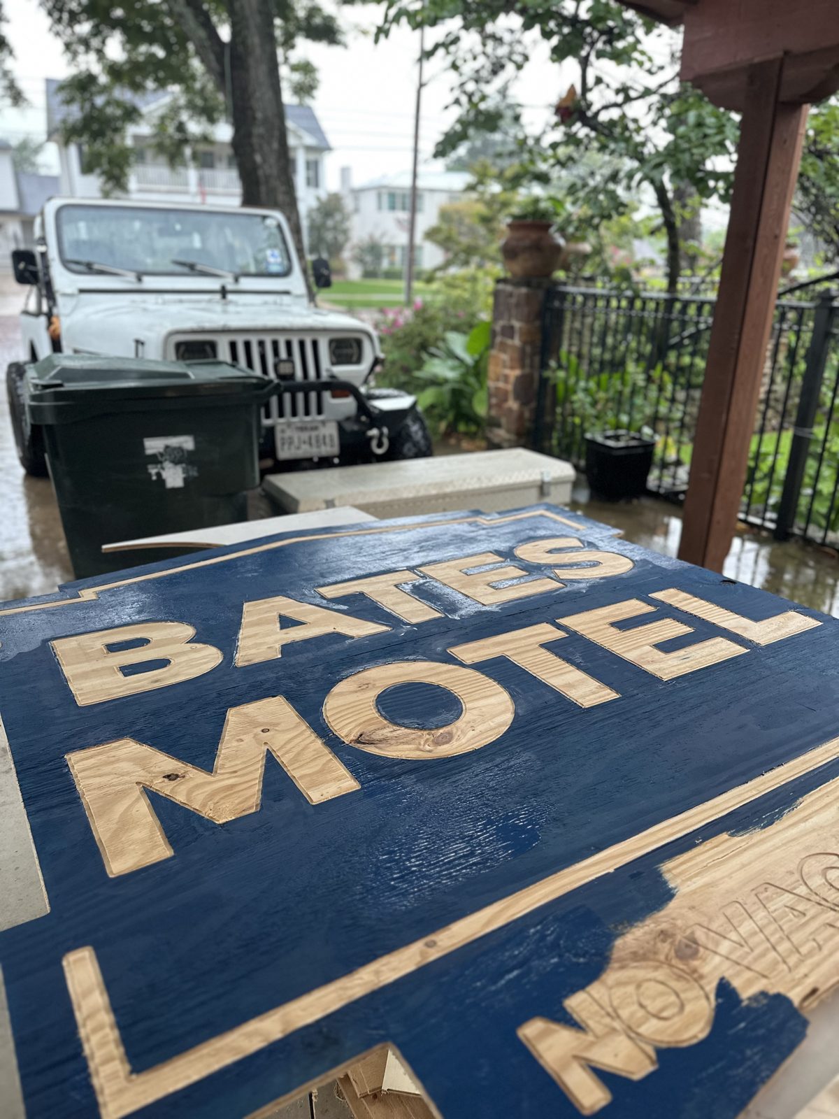 Bates Motel sign with blue base coat and unpainted carved letters