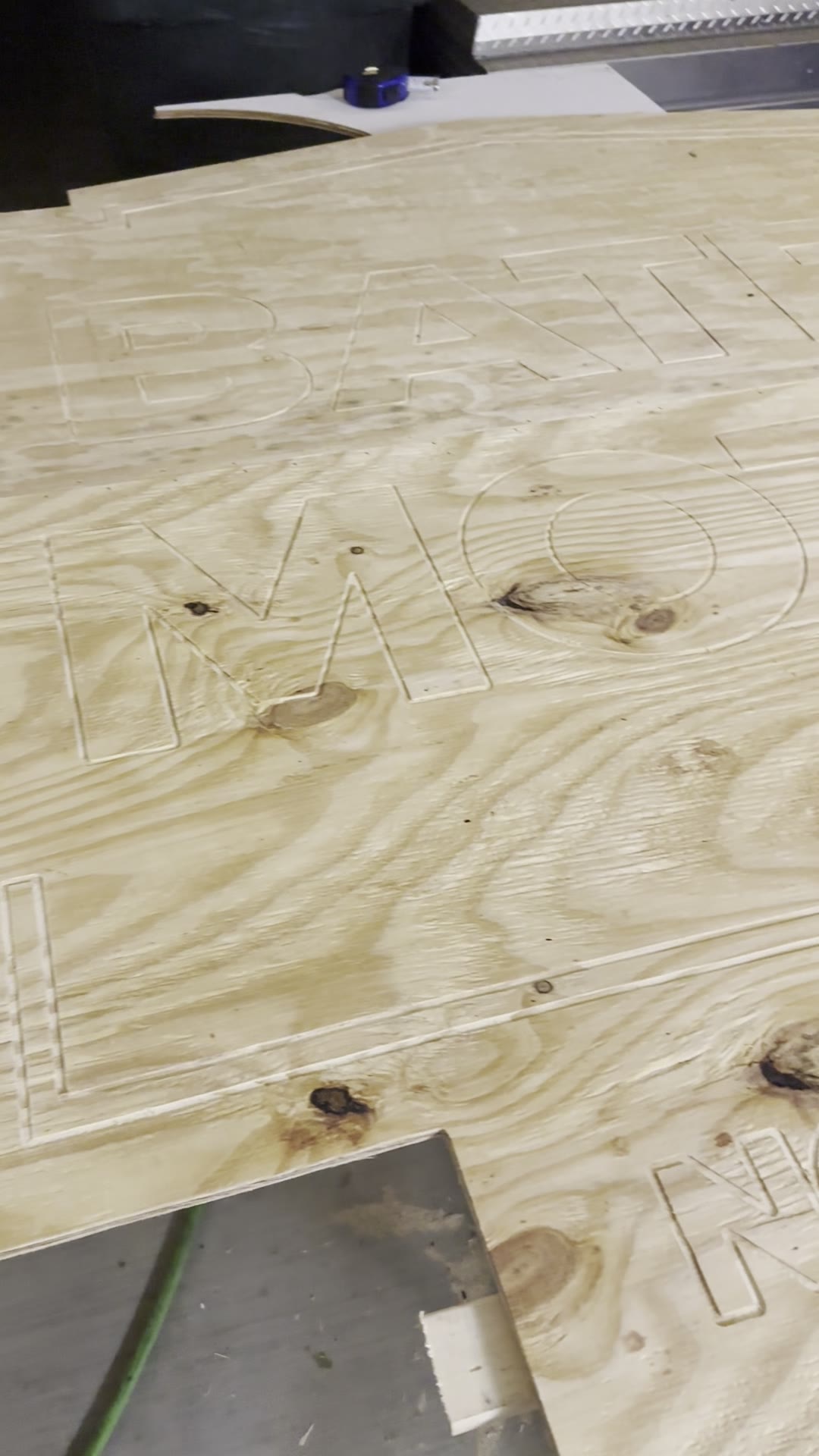 CNC-carved letter outlines on the plywood Bates Motel sign